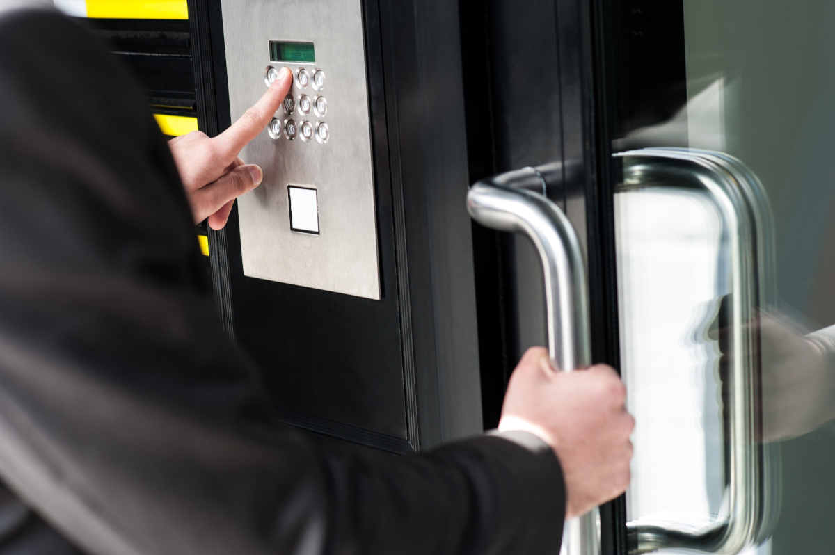 A person using a keypad to gain access to a building