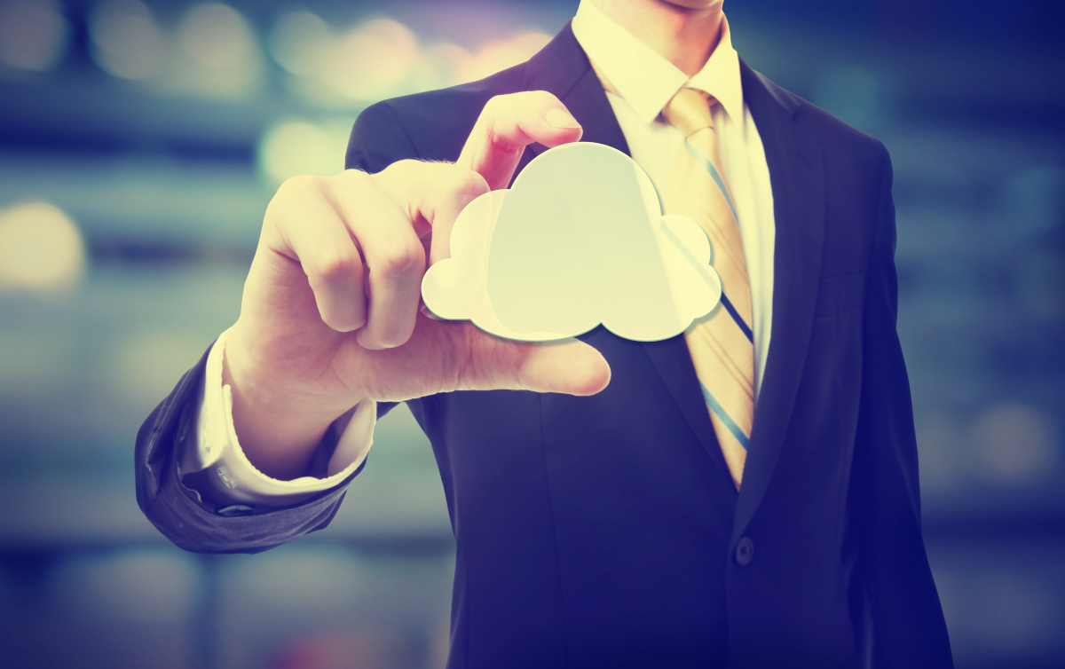 A businessman holding a cloud between his fingers