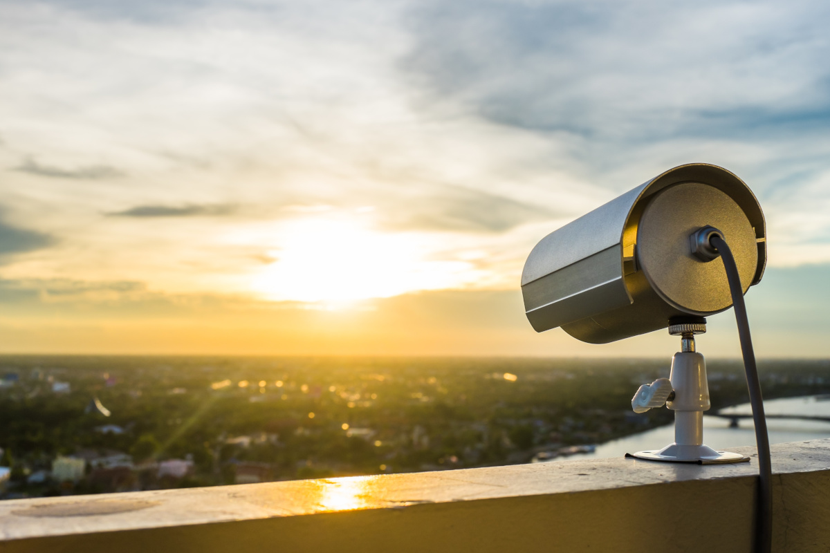 A surveillance camera on top of a roof