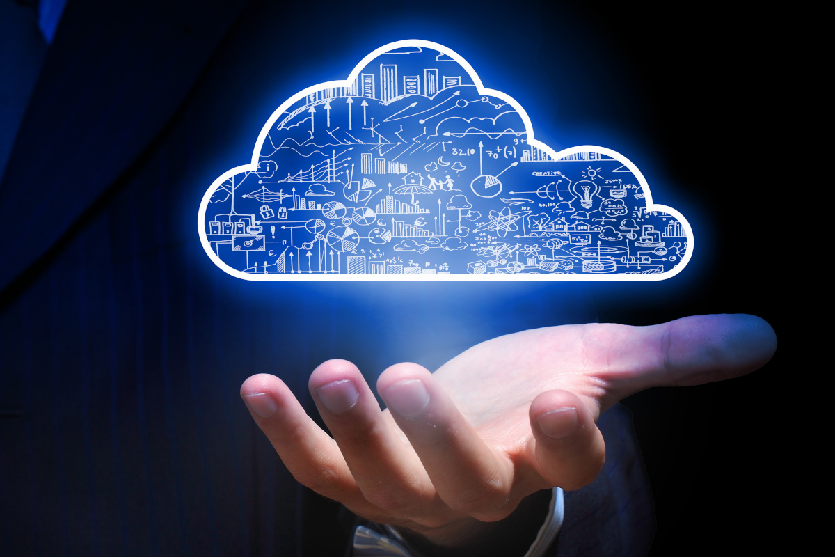 A hand with a digital cloud above it representing cloud backup services