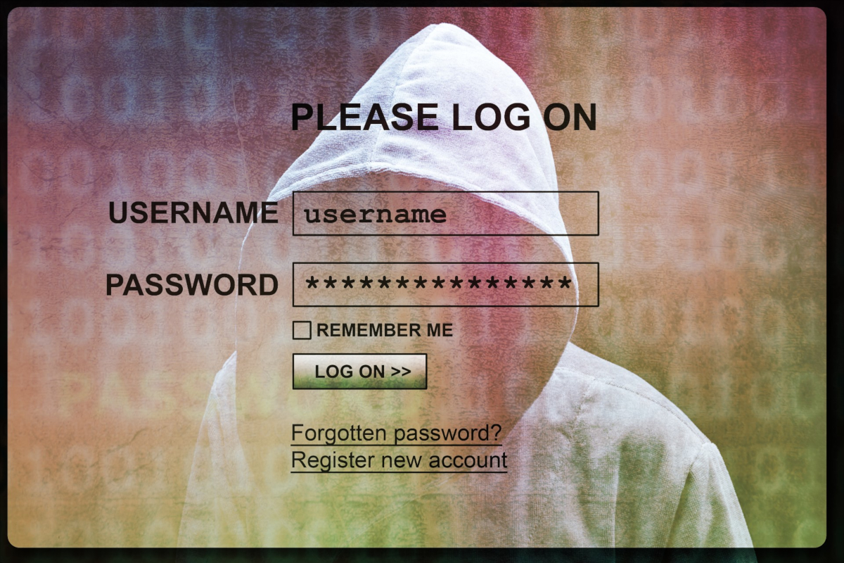 A login screen with a man in a hoodie hunching behind it to reflect cyber security.