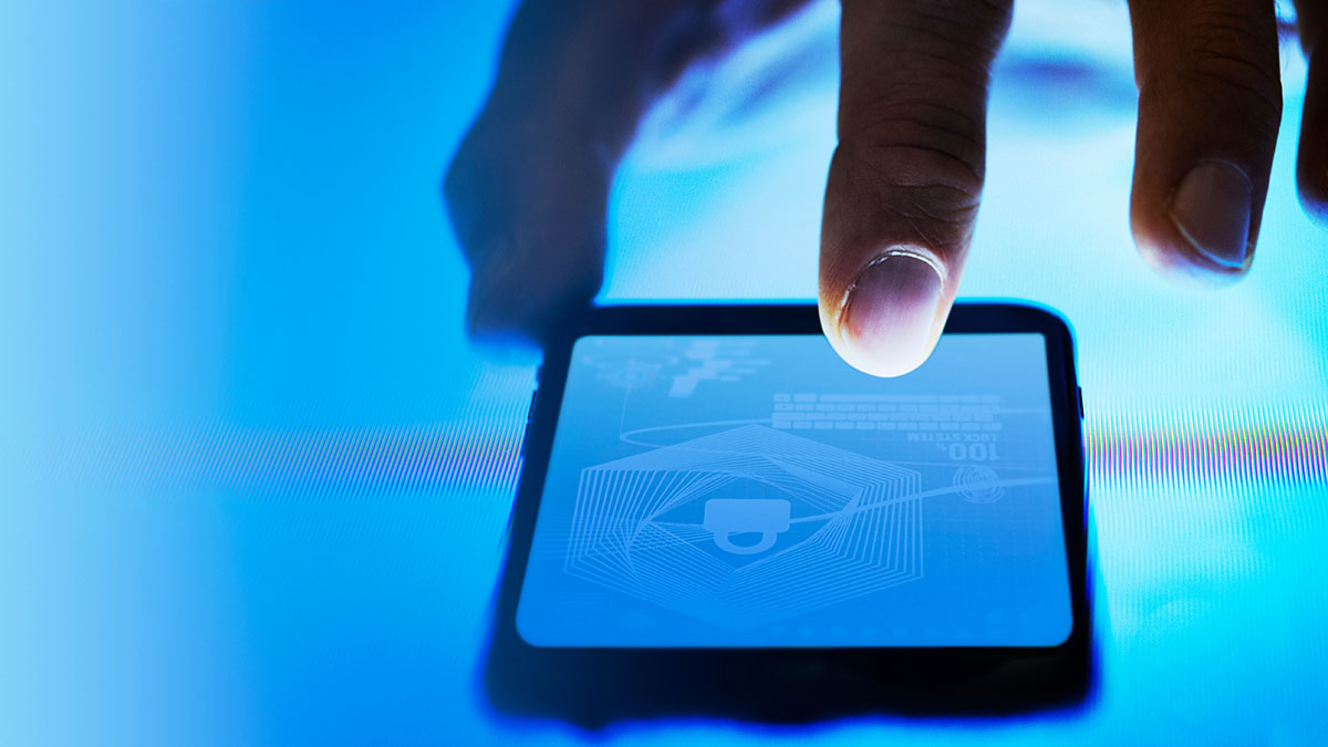 Man scanning his finger on his phone screen.